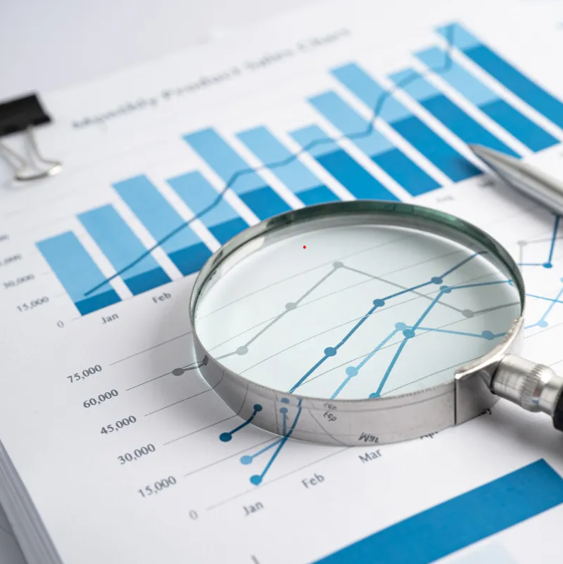 Data analysis and research - magnifying glass over charts and graphs
