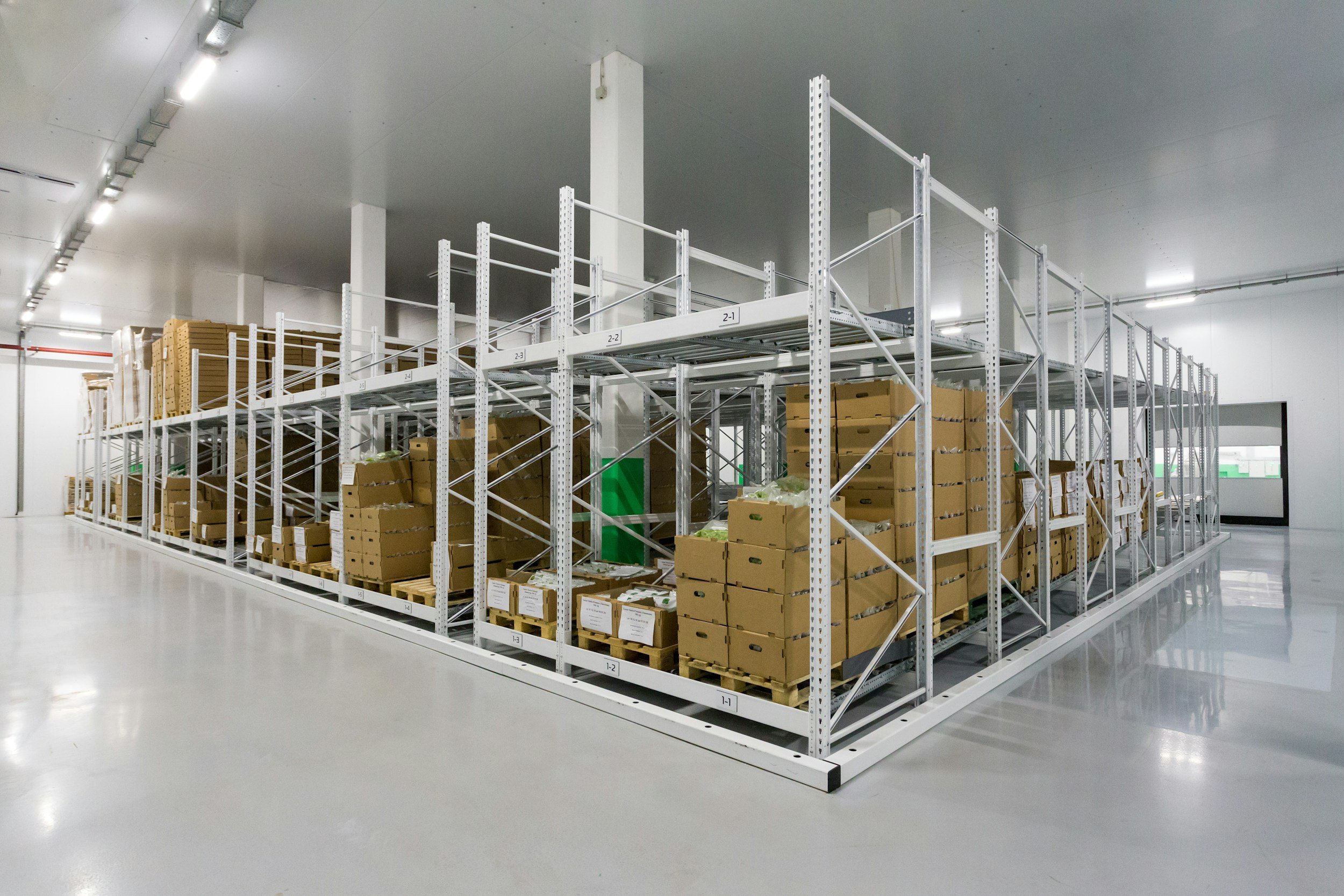 Warehousing and distribution - modern warehouse interior with tall metal shelving units